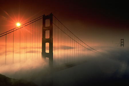 Golden Gate Bridge shrouded in for at sunrise from the Marin headlands